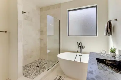 a bathroom with a tub and a glass shower at Walk to Ski Lift Granby Ranch Family Retreat! in Granby
