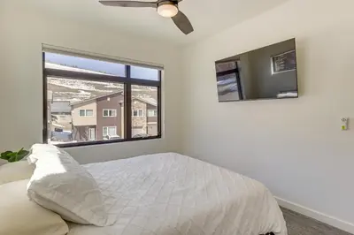 a bedroom with a bed and a large window at Walk to Ski Lift Granby Ranch Family Retreat! in Granby