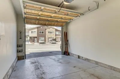 a garage with a door open to a parking lot at Walk to Ski Lift Granby Ranch Family Retreat! in Granby