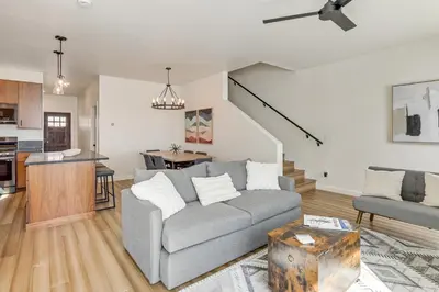 a living room with a couch and a kitchen at Walk to Ski Lift Granby Ranch Family Retreat! in Granby