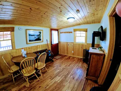 a room with a table and chairs and a wooden ceiling at Arapaho in Grand Lake