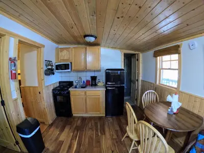 a kitchen with a table and a wooden ceiling at Arapaho in Grand Lake