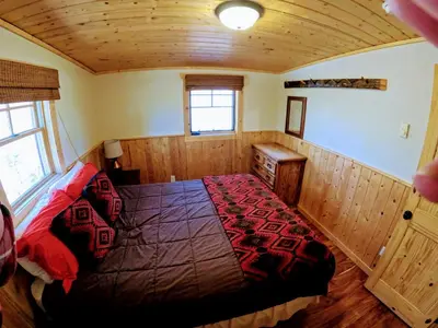 a bedroom with a bed in a wooden room at Arapaho in Grand Lake