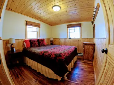 a bedroom with a bed in a wooden house at Arapaho in Grand Lake