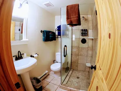 a bathroom with a shower and a toilet and a sink at Arapaho in Grand Lake
