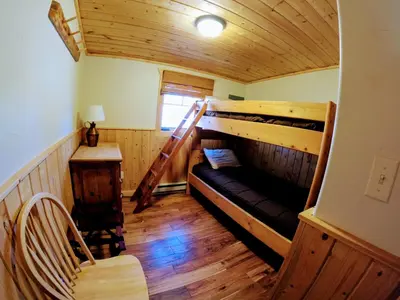a room with two bunk beds in a cabin at Arapaho in Grand Lake