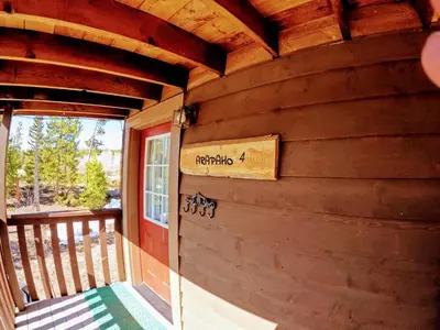 a sign on the side of a wooden house at Arapaho in Grand Lake