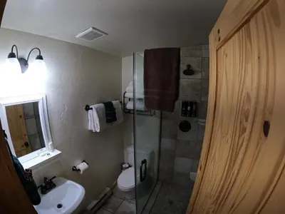 a bathroom with a shower and a toilet and a sink at Shadow Mountain in Grand Lake