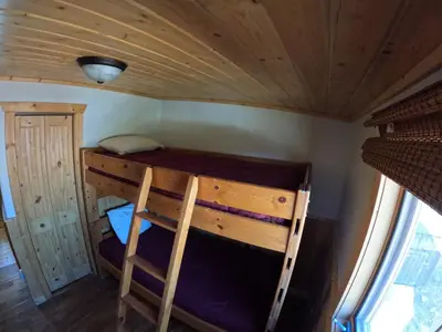 a bunk bed in a cabin with a wooden ceiling at Shadow Mountain in Grand Lake