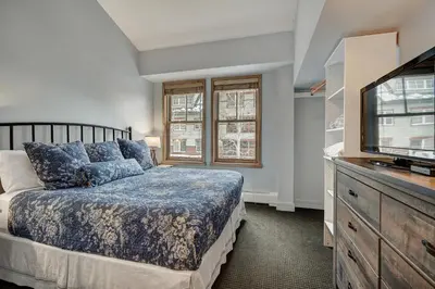 a bedroom with a bed and a flat screen tv at Fantastic Mountain Home Near Ski Lifts condo in Keystone