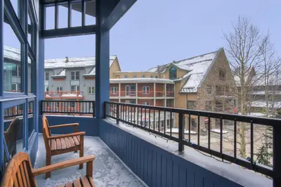 a balcony with two chairs and a view of buildings at Fantastic Mountain Home Near Ski Lifts condo in Keystone