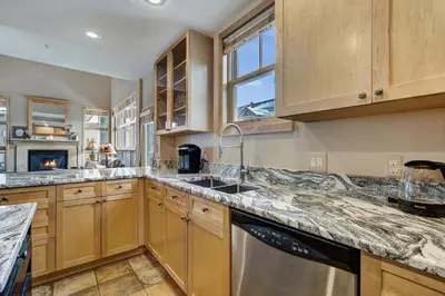 a kitchen with wooden cabinets and a sink at Fantastic Mountain Home Near Ski Lifts condo in Keystone