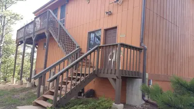 a building with stairs on the side of it at Cabin in the Woods in Red Feather Lakes