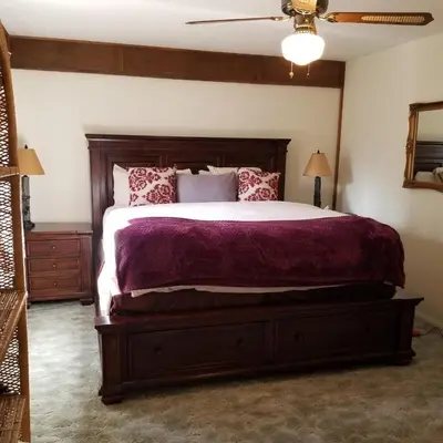a bedroom with a large bed with purple sheets at Cabin in the Woods in Red Feather Lakes