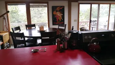 a restaurant with a table and a table and chairs at Cabin in the Woods in Red Feather Lakes