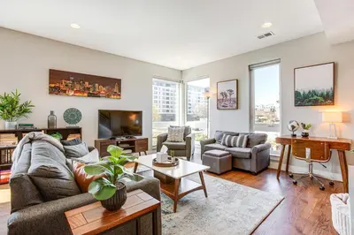 a living room with a couch and a table at Walk to Mile High Stadium Modern Denver Townhome in Denver