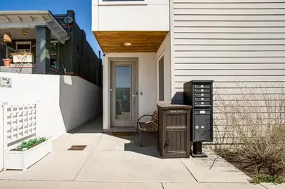 a house with a desk in front of a door at Walk to Mile High Stadium Modern Denver Townhome in Denver