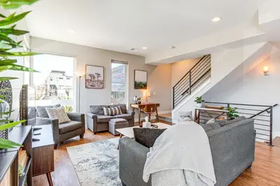 a living room with a gray couch and chairs at Walk to Mile High Stadium Modern Denver Townhome in Denver