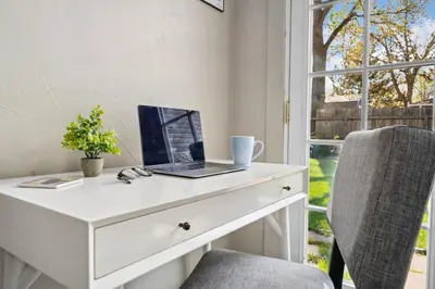 a white desk with a laptop on it next to a window at Magnolia Hideaway Pet Friendly with Fireplace in Fort Collins