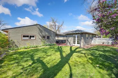 a house with a large lawn in front of it at Magnolia Hideaway Pet Friendly with Fireplace in Fort Collins