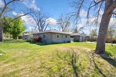 a house in a yard with a tree at Magnolia Hideaway Pet Friendly with Fireplace in Fort Collins