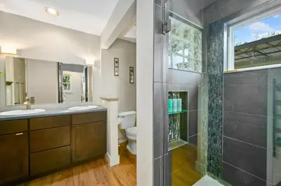 a bathroom with a toilet and a glass shower at Magnolia Hideaway Pet Friendly with Fireplace in Fort Collins