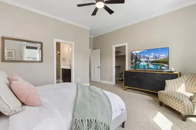 a bedroom with a bed and a flat screen tv at Decked Out Sunset Views, Fire Pit & Fenced Yard in Fort Collins