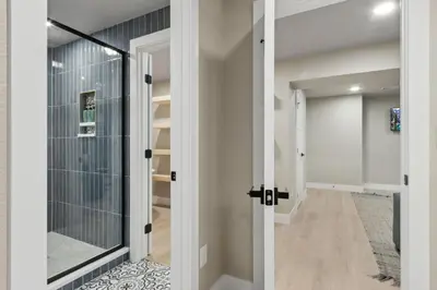 a hallway with a glass door leading into a room at Decked Out Sunset Views, Fire Pit & Fenced Yard in Fort Collins