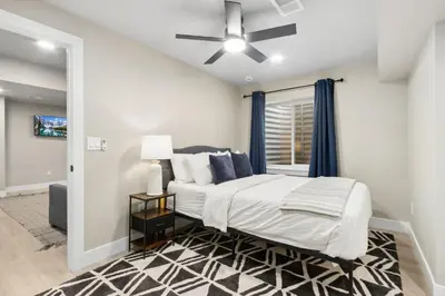 a bedroom with a bed and a ceiling fan at Decked Out Sunset Views, Fire Pit & Fenced Yard in Fort Collins