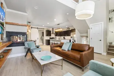 a living room with a couch and a table at Decked Out Sunset Views, Fire Pit & Fenced Yard in Fort Collins