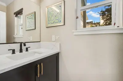 a bathroom with a white sink and a window at Decked Out Sunset Views, Fire Pit & Fenced Yard in Fort Collins