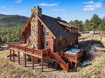 a log cabin with a large deck and a swimming pool at The Broadmeadow Cabin - VR-25-0005 cabin in Lyons