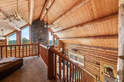 a log cabin with a couch and a fireplace at The Broadmeadow Cabin - VR-25-0005 cabin in Lyons