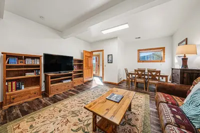a living room with a couch and a tv at The Broadmeadow Cabin - VR-25-0005 cabin in Lyons