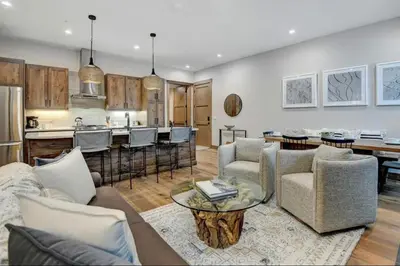 a living room with a couch and a table at 4BR Winter Park Oasis - Sleeps 9 - Ski-In and Hot Tub in Winter Park