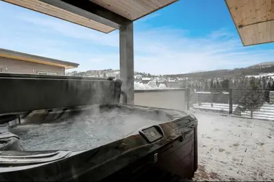 a large outdoor hot tub with a view of a snow covered at 4BR Winter Park Oasis - Sleeps 9 - Ski-In and Hot Tub in Winter Park