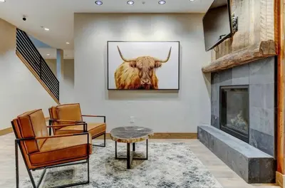 a living room with a picture of a bull on the wall at 4BR Winter Park Oasis - Sleeps 9 - Ski-In and Hot Tub in Winter Park