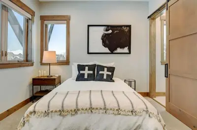 a bedroom with a large bed and a window at 4BR Winter Park Oasis - Sleeps 9 - Ski-In and Hot Tub in Winter Park