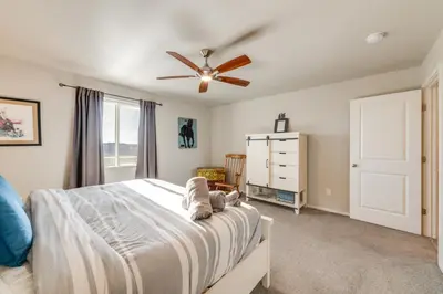 a bedroom with a bed and a ceiling fan at 11 Mi to Fort Collins Wellington Retreat with Patio in Wellington