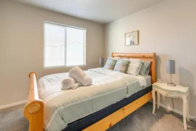 a bedroom with a bed with two towels on it at 11 Mi to Fort Collins Wellington Retreat with Patio in Wellington