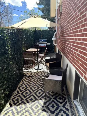 a patio with chairs and a table with an umbrella at Quiet Denver Hampden Neighborhood - Tech Center in Denver