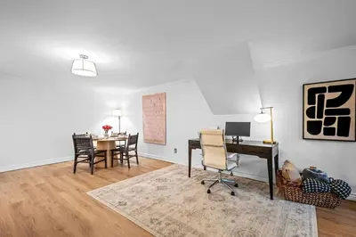 a living room with a desk and a table with chairs at Quiet Denver Hampden Neighborhood - Tech Center in Denver