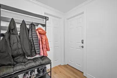 a walk in closet with a bench with coats at Quiet Denver Hampden Neighborhood - Tech Center in Denver