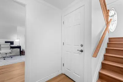 an open white door in a room with a staircase at Quiet Denver Hampden Neighborhood - Tech Center in Denver