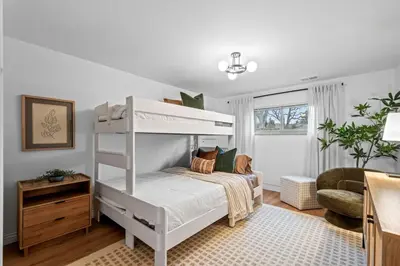 a bedroom with a white bunk bed and a chair at Quiet Denver Hampden Neighborhood - Tech Center in Denver