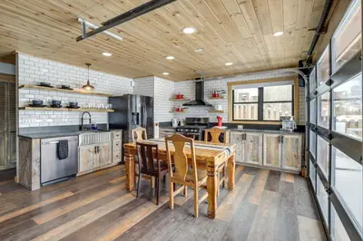 a large kitchen with a wooden table and chairs at Modern Granby Retreat Fish, Hike and Relax! in Granby