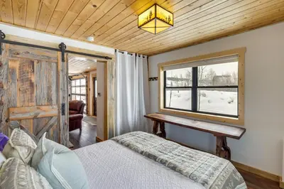 a bedroom with a bed and a window at Modern Granby Retreat Fish, Hike and Relax! in Granby