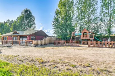 a home with a playground and a house at Modern Granby Retreat Fish, Hike and Relax! in Granby
