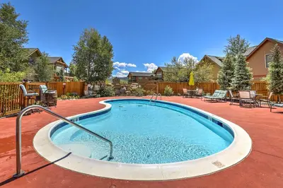 a swimming pool in a yard with chairs and tables at Modern Granby Retreat Fish, Hike and Relax! in Granby
