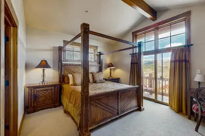 a bedroom with a canopy bed and a window at Trailside Tranquility in Winter Park